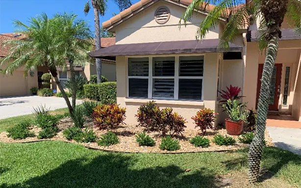 A refreshed front garden with new low-maintenance planting and river rock